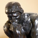 Sculpture of a person deep in thought.