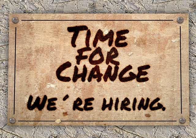 a sign reading "time for change. we're hiring"