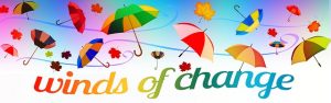 multicoloured umbrellas and leaves blowing in the wind, with the text "winds of chage"