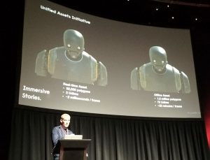 a side by side comparison of Rogue One's K-2SO as created by Renderman and Unreal Engine, on the screen above Eoghan Cunneen.